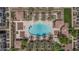 Aerial view of a community pool surrounded by palm trees, shaded cabanas, and lounge chairs for relaxing in the sun at 2658 S Sulley Dr # 102, Gilbert, AZ 85295