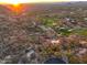 Aerial view of luxury home featuring mountain views, lush desert landscape, and a nearby golf course at 26796 N 98Th Way, Scottsdale, AZ 85262