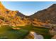 Panoramic view of golf course and desert homes nestled amid picturesque mountains at 26796 N 98Th Way, Scottsdale, AZ 85262