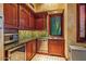 Stylish bar area features custom cabinetry, stainless steel appliances, and tiled backsplash at 26796 N 98Th Way, Scottsdale, AZ 85262