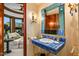 Elegant bathroom with blue stone vanity, gold fixtures, and sitting room access at 26796 N 98Th Way, Scottsdale, AZ 85262