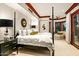 Primary bedroom with a four-poster bed, sitting area, and bay window at 26796 N 98Th Way, Scottsdale, AZ 85262