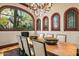 Dining area showcasing chandelier and backyard views through leaded windows at 26796 N 98Th Way, Scottsdale, AZ 85262