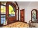 Elegant foyer showcases custom woodwork, unique flooring, and a grand wooden door at 26796 N 98Th Way, Scottsdale, AZ 85262