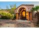 Grand entryway features a stone archway, stately pillars, and meticulous brickwork at 26796 N 98Th Way, Scottsdale, AZ 85262