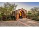 Grand entryway features a stone archway, stately pillars, and meticulous brickwork at 26796 N 98Th Way, Scottsdale, AZ 85262