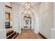 Hallway with arched openings, wood and brick accents, and overhead lighting at 26796 N 98Th Way, Scottsdale, AZ 85262