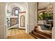 Hallway with arched openings, stairs to upper level, dining area to right at 26796 N 98Th Way, Scottsdale, AZ 85262