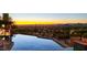 Sunset view from the infinity pool overlooking the city and mountains, creating a serene oasis at 26796 N 98Th Way, Scottsdale, AZ 85262