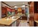 Spacious kitchen featuring custom wood cabinetry, stainless steel appliances, and a large island with stone countertops at 26796 N 98Th Way, Scottsdale, AZ 85262