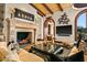 Cozy living room featuring a stone fireplace, and vaulted wood ceilings, a flat-screen TV, and a comfortable seating area at 26796 N 98Th Way, Scottsdale, AZ 85262