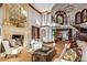 Elegant living room with fireplace, spiral staircase, and soaring ceilings at 26796 N 98Th Way, Scottsdale, AZ 85262
