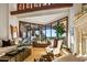 Cozy living room features large windows, stone fireplace, and comfortable seating at 26796 N 98Th Way, Scottsdale, AZ 85262