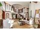 Spacious living room with soaring ceilings, elegant columns, and natural light at 26796 N 98Th Way, Scottsdale, AZ 85262
