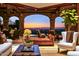 Living room with amazing sunset views, hardwood floors, elegant décor and stone arches at 26796 N 98Th Way, Scottsdale, AZ 85262