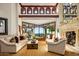 Bright living room with high ceilings, fireplace, large picture window, and sophisticated decor at 26796 N 98Th Way, Scottsdale, AZ 85262