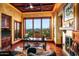A formal office space with wood finishes, fireplace, and a large window offering a scenic view at 26796 N 98Th Way, Scottsdale, AZ 85262