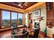 A formal office space with wood finishes, fireplace, and a large window offering a scenic view at 26796 N 98Th Way, Scottsdale, AZ 85262