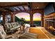 Outdoor patio with fireplace, comfortable seating, stone arches, beautiful views, and swimming pool at 26796 N 98Th Way, Scottsdale, AZ 85262