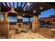 Patio with fireplace, mountain views, custom stone finishes, and comfortable outdoor seating at 26796 N 98Th Way, Scottsdale, AZ 85262