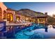 Inviting backyard pool with tile detail, poolside lounge area, and outdoor kitchen with mountain views at 26796 N 98Th Way, Scottsdale, AZ 85262