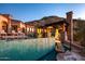 Backyard pool area with lounging and outdoor kitchen amenities set against a hillside at 26796 N 98Th Way, Scottsdale, AZ 85262