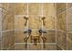 Close-up of the intricate tile work and hardware in a luxurious shower at 26796 N 98Th Way, Scottsdale, AZ 85262
