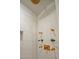 Elegant shower featuring gold fixtures and tile, with a built in shelf at 26796 N 98Th Way, Scottsdale, AZ 85262