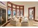Inviting sitting area featuring a fireplace, white decor, and scenic views at 26796 N 98Th Way, Scottsdale, AZ 85262