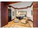 Sitting area with two chairs, table, and dark wood trim and black armoire at 26796 N 98Th Way, Scottsdale, AZ 85262