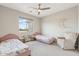 Bedroom featuring two beds, a ceiling fan, and a window with a view at 27420 N 170Th St, Rio Verde, AZ 85263
