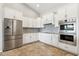Bright kitchen boasts white cabinets, stainless steel appliances, and plenty of counter space for cooking and entertaining at 27420 N 170Th St, Rio Verde, AZ 85263
