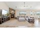 Spacious living room features a stone fireplace, large sectional sofa, and expansive windows offering desert views at 27420 N 170Th St, Rio Verde, AZ 85263