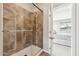 Modern shower featuring a frameless glass door and tiled surround at 27420 N 170Th St, Rio Verde, AZ 85263