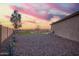 Landscaped backyard with desert features, artificial turf, and privacy wall, creating a serene outdoor space at 30370 N Opal Dr, San Tan Valley, AZ 85143