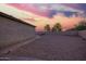 Expansive backyard featuring desert landscaping, fire pit, and mature trees, perfect for outdoor living at 30370 N Opal Dr, San Tan Valley, AZ 85143