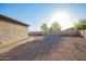 Spacious backyard featuring desert landscaping, a fire pit, and mature trees, ideal for relaxation and entertainment at 30370 N Opal Dr, San Tan Valley, AZ 85143