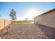 Well-maintained backyard featuring desert landscape, artificial turf, and privacy fence, perfect for outdoor enjoyment at 30370 N Opal Dr, San Tan Valley, AZ 85143