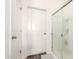 Bathroom features glass shower door and white cabinets at 30370 N Opal Dr, San Tan Valley, AZ 85143