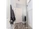 Entry to bathroom features modern finishes, wood-look floors, and sleek gray towels hanging on the door at 30370 N Opal Dr, San Tan Valley, AZ 85143