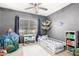 A room with a dinosaur theme, a window for light, and gray paint at 30370 N Opal Dr, San Tan Valley, AZ 85143