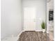 Entryway with wood-look floors, neutral paint and a simple white front door at 30370 N Opal Dr, San Tan Valley, AZ 85143