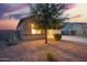 Well-maintained single-story home with a two-car garage and desert landscaping at dusk at 30370 N Opal Dr, San Tan Valley, AZ 85143