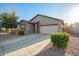Traditional single-story home with a two-car garage and low-maintenance desert landscaping at 30370 N Opal Dr, San Tan Valley, AZ 85143