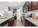 This gourmet kitchen features granite counters, stainless steel appliances, and dark wood cabinets at 30370 N Opal Dr, San Tan Valley, AZ 85143