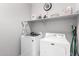 Functional laundry room features modern front-load washer and dryer, as well as practical shelving and storage at 30370 N Opal Dr, San Tan Valley, AZ 85143