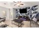 Stylish living room with modern wall decor, comfortable seating, and a ceiling fan at 30370 N Opal Dr, San Tan Valley, AZ 85143