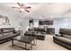 Open-concept living room with a large sectional sofa and seamless access to the kitchen at 30370 N Opal Dr, San Tan Valley, AZ 85143