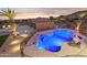 Aerial view of backyard featuring pool, bar stools, spa, and desert landscaping at 3312 N 89Th Pl, Mesa, AZ 85207
