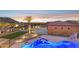 Aerial view of backyard featuring resort style pool, patio, garage and green space at 3312 N 89Th Pl, Mesa, AZ 85207